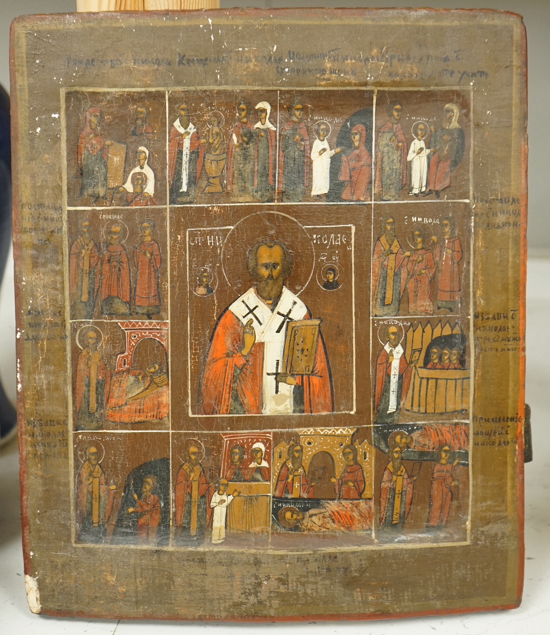 19th century Russian school, Icon, Life of St Nicholas, incised inscription verso, 31 x 26cm